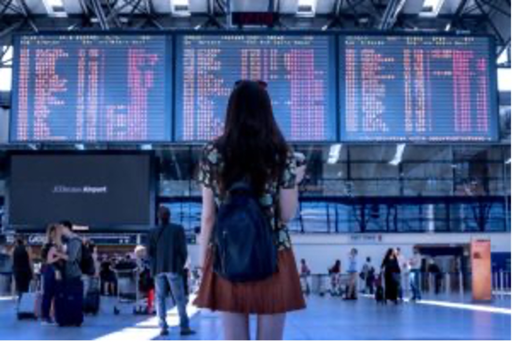 Lady looking at billboard on the airport